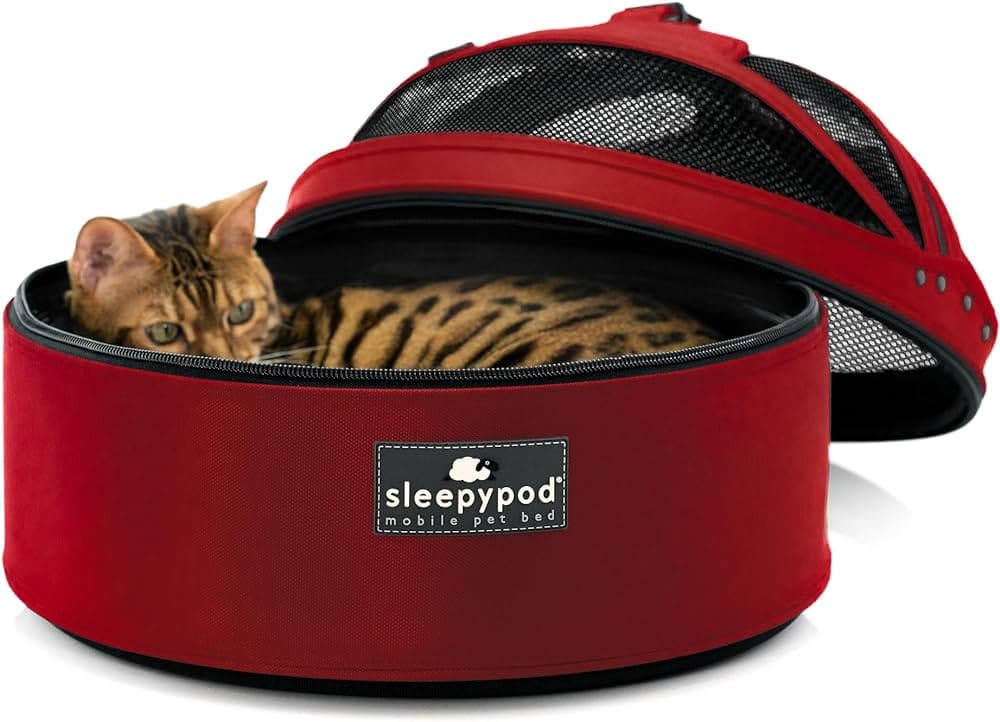 a cat laying in a The Moveable Pet Bed Sleepypod